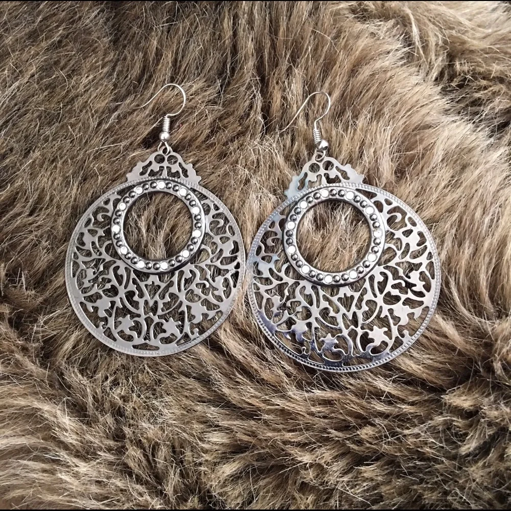 Large chrome tone scroll rhinestone earrings